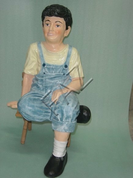 Decor figure designed as a boy in blue pants sitting on a chair 75x50cm