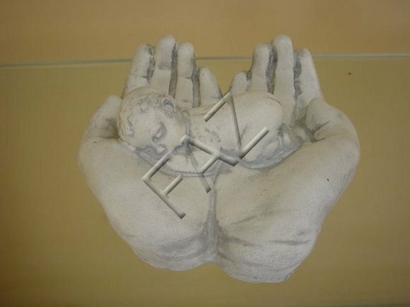 Full white colored decor figure of hands holding a baby 18cm