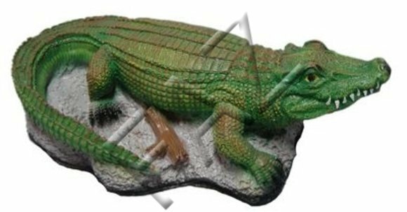 Motley green colored decorative sculpture designed as crocodile on a stone 12x35cm