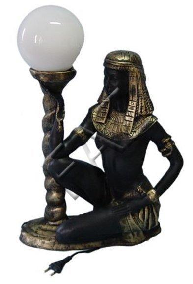 Black gold colored decor light designed as a sitting ancient egyptian servant with a lamp