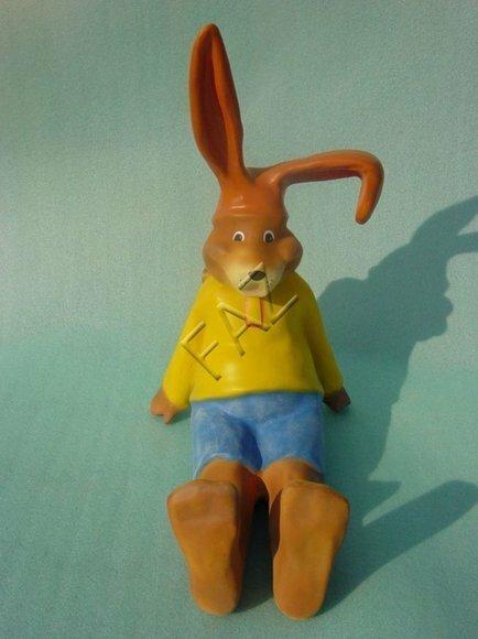 Light brown rabbit in yellow shirt & blue shorts with long ears sitting on a floor 53x42cm c458