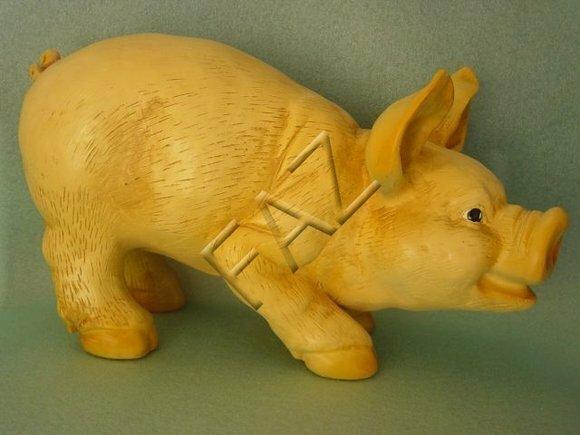 Full yellow colored decorative sculpture designed as playing piglet 22x38cm