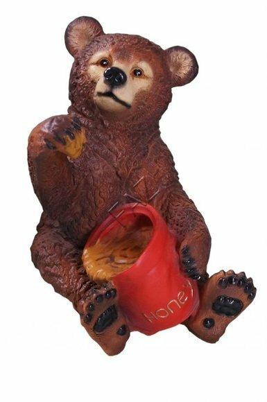 Decorative sculpture designed as dark brown colored bear cub eating honey 50x39cm