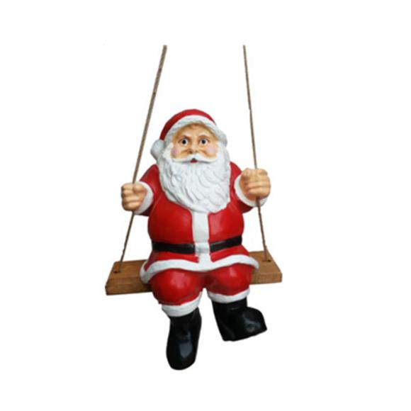 Christmas decorative sculpture designed as a red colored santa claus on a swing 50cm